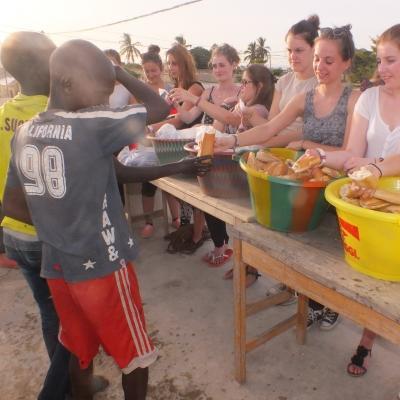 A Projects Abroad group hands out food for their volunteer work with children in Senegal. A group hands out food while they volunteer with children in Senegal.